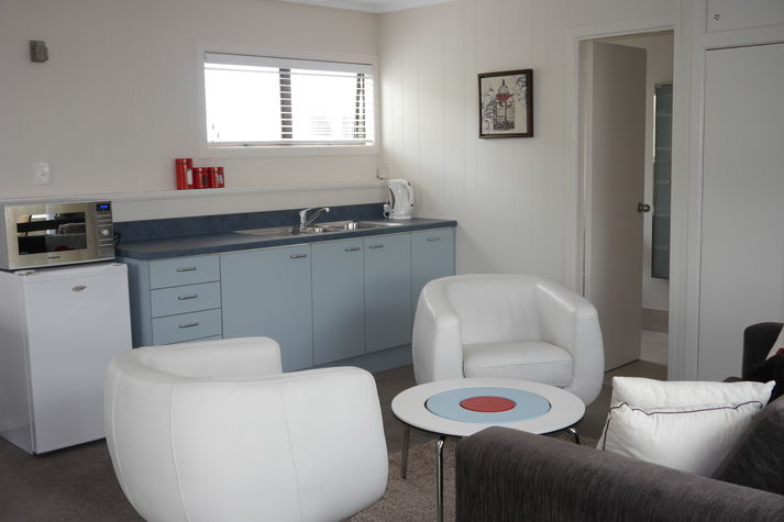 A view from the lounge area to the kitchenette and bathroom.