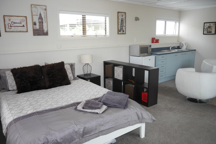 Looking from the bedroom area to the lounge and kitchenette.
