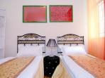 red and golden bedrooms with 2 single beds