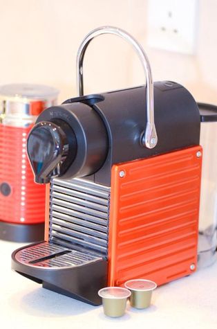 Nespresso machine and capsules are provided
