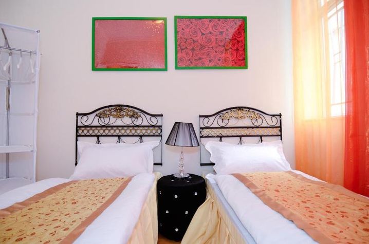 red and golden bedrooms with 2 single beds