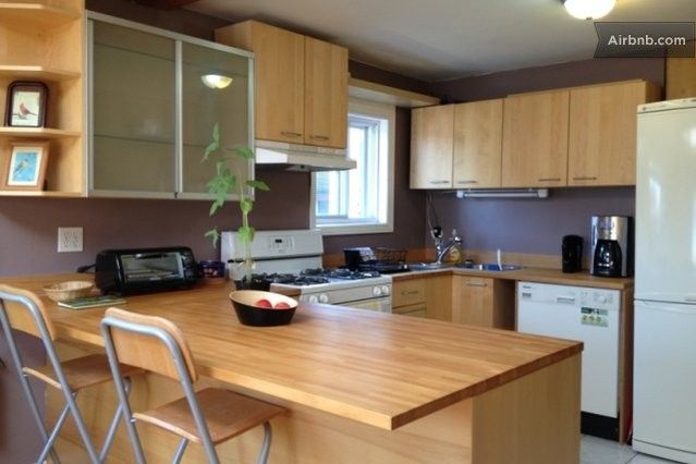 Kitchen includes a dishwasher, pots and pans, dishes, microwave.