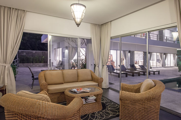 Comfortable lounge space with wicker furniture.