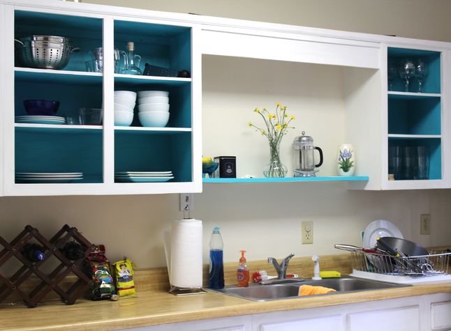 Kitchen cabinets w/ distressed wood, coastal feel.