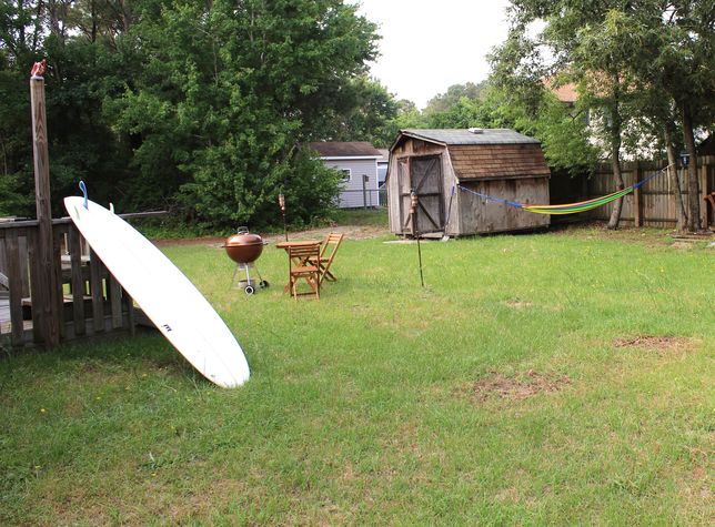 Private backyard with grills and hammock.
