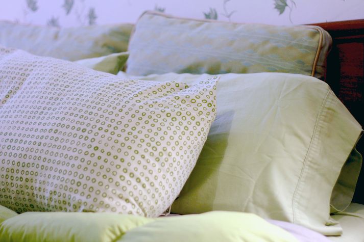 Fluffy pillows in this quiet bedroom.