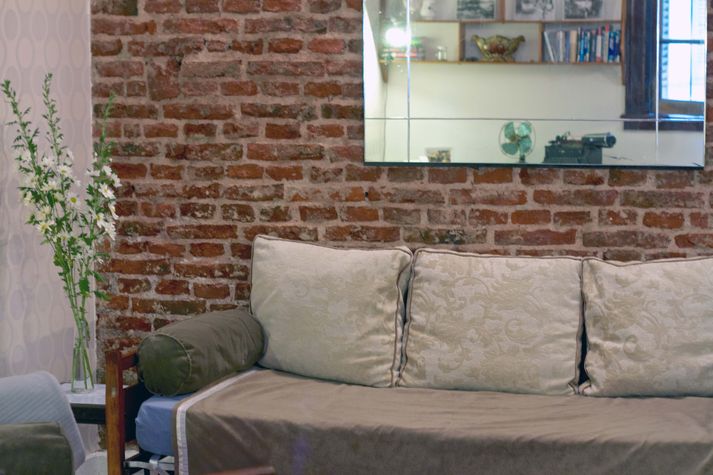 Vintage mirror and exposed brick walls.