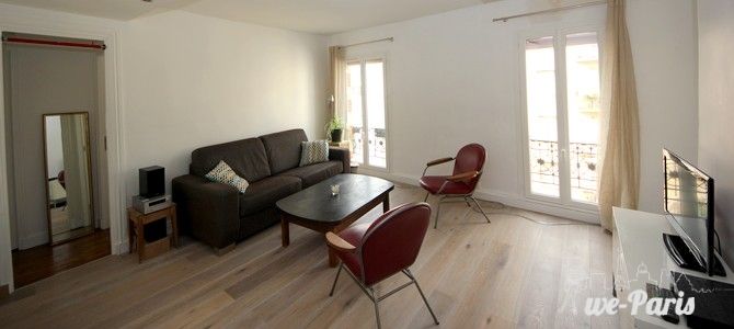 Bright and comfortable living room with a nice view of the street. #ParisApartmentRentals