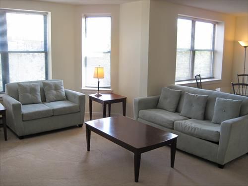 Comfortable living room with sofa bed and club chair.