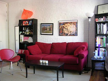 living room furniture has changed slightly e.g. bookshelves replaced with lower drawers, coffee table and side chair removed to create a more open concept