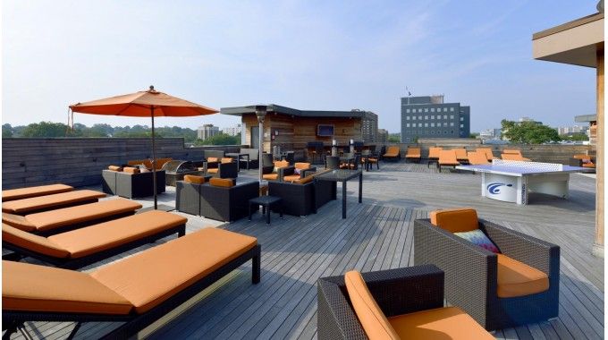 Sky terrace with lots of seating, outdoor grills & fire pits and city views