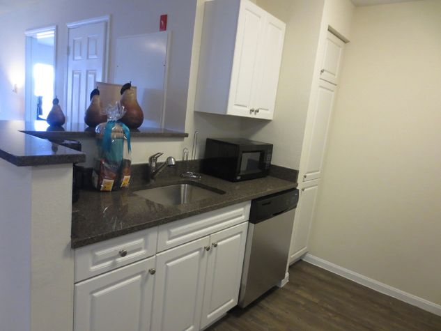 Fully equipped kitchen with granite counter tops and pass-through to the dining area