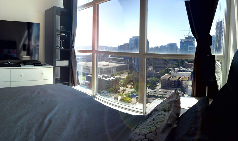 Queen bed with city view and TV