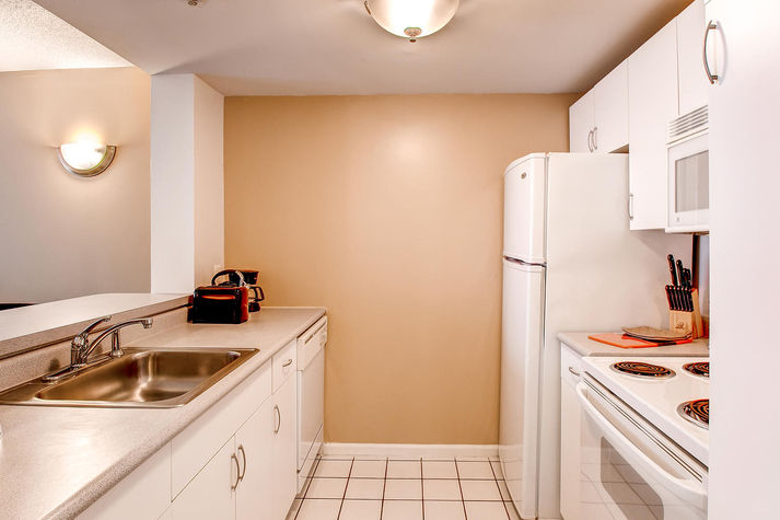 Fully equipped kitchen with convenient pass-through to the dining area