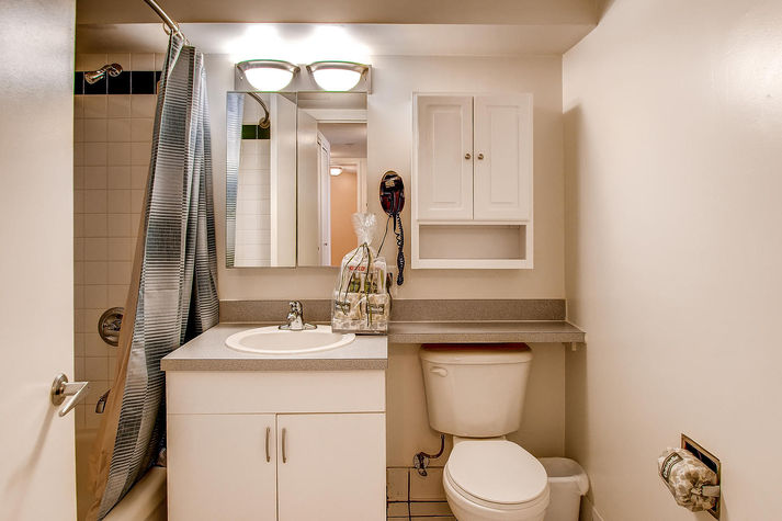 Large bathroom with shower/tub combination; towels and toiletry samples provided