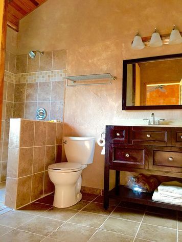 Three piece bathroom has large window right in the shower stall for that "outdoor shower" feel