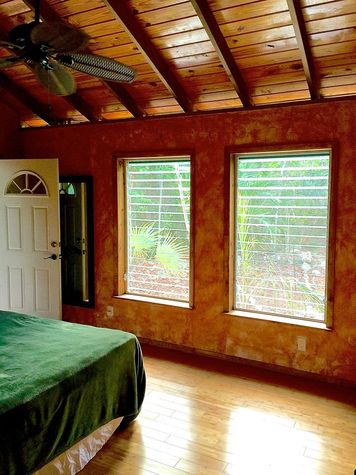 Large louvered windows as vaulted ceilings allow for optimum fresh air