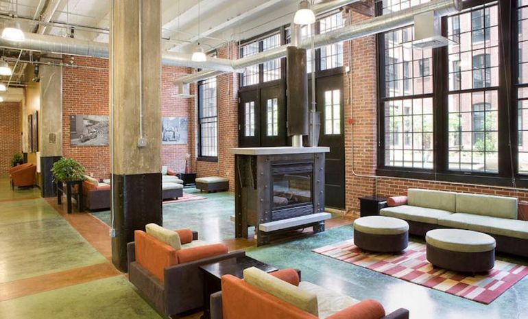 Beautiful lobby with fireplace, high ceilings, exposed bricks and over-sized windows