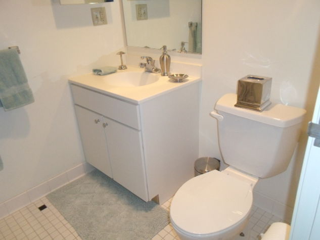 Large bathroom with shower/tub combination; towels and toiletry samples provided