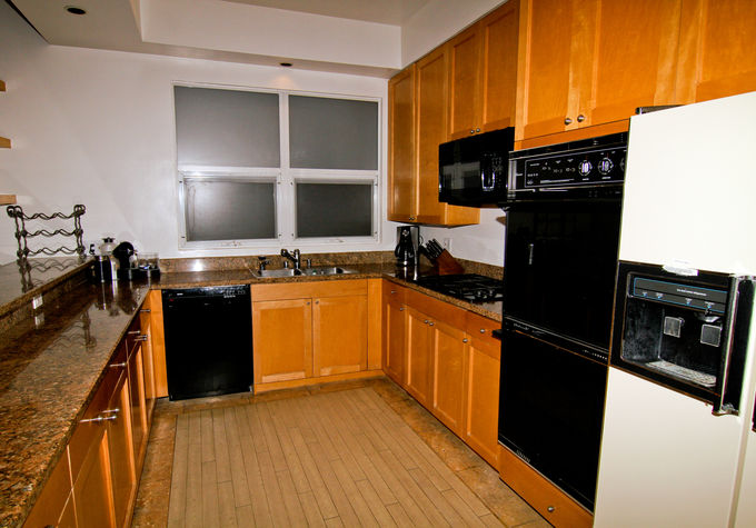 The kitchen and granite breakfast bar overlook the sand and sunsets.