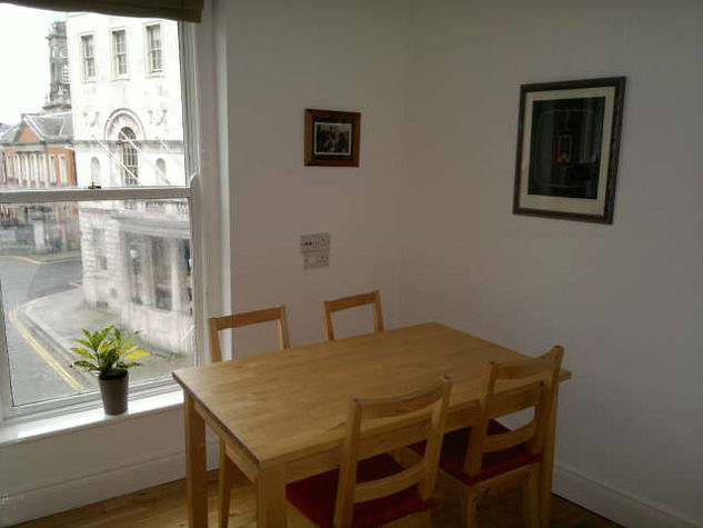 At the other side of the living room, there's a dining area by the window