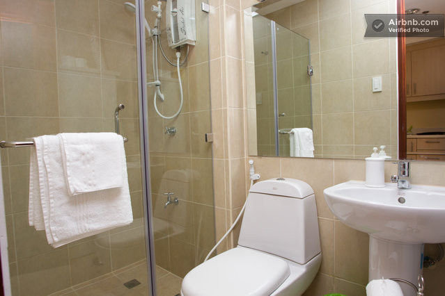 Tempered glass shower enclosure; water heater for shower; mirror with vanity lighting