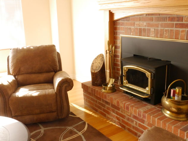 Recliner reading chair by the fire.