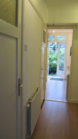 Hall view toward the kitchen and onto garden