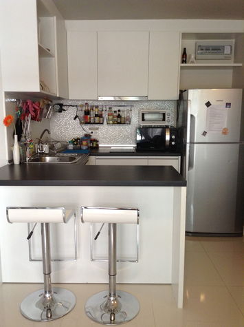 Fully equipped kitchen with microwave, toaster, electric water kettle, stove, pots, cutlery and utensils