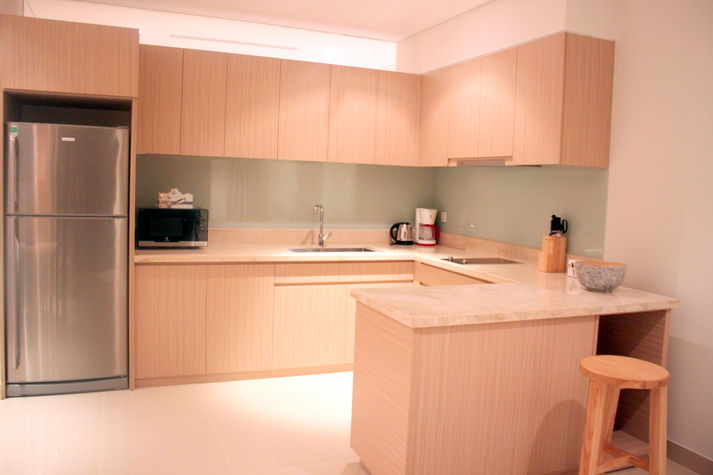 The self-contained kitchen with new branded facilities. The washing machine is under the table top.