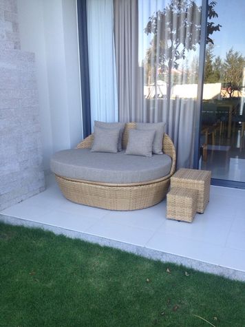 Relaxation couch on the apartment patio by the garden