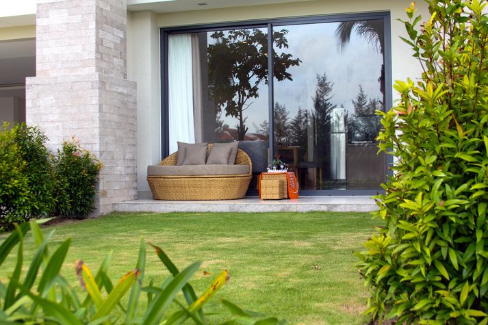 The huge sun lounge couch on our patio looks over the garden and the pool.