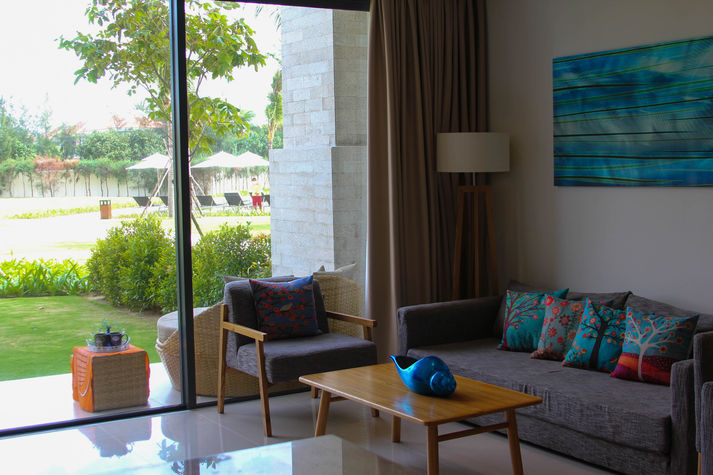 The large living room looks over a beautiful garden and the huge pool.