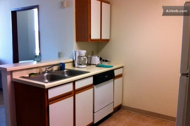 Kitchen with plates, glasses, toaster, coffee, utensils