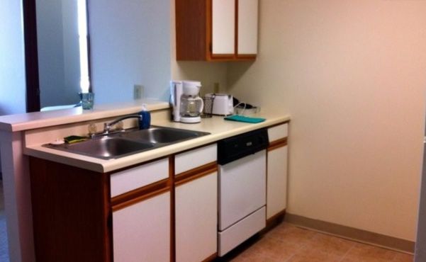 Kitchen with plates, glasses, toaster, coffee, utensils