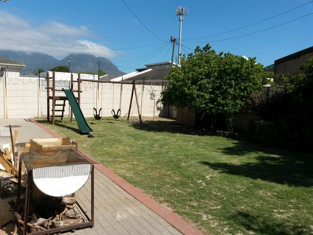 Backyard with a play park for the little ones
