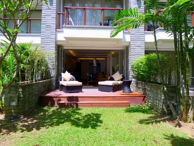 Private terrace with sun beds and a lawn