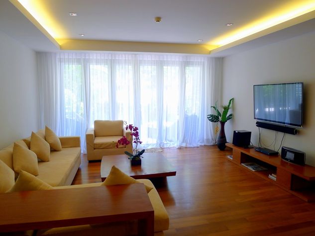 Spacious living area with a large flat screen TV, DVD and sound system