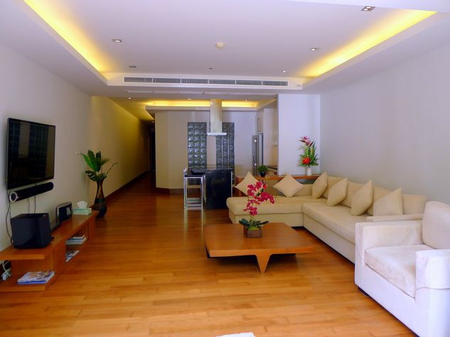Open space living room with TV and european kitchen with dining area