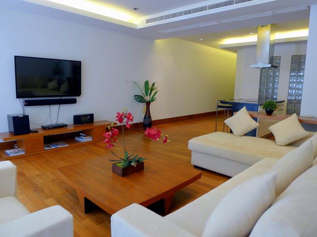 Comfortable sofa with arm chair, large TV with sound system in the living room
