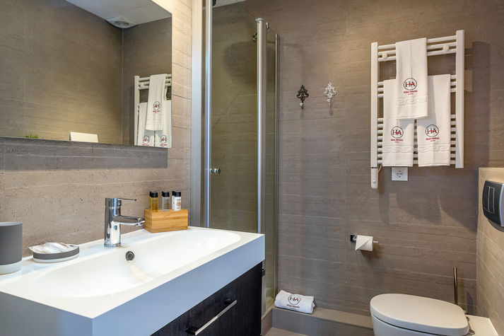 Bathroom with shower and towels heater