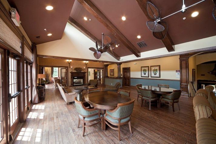 Common area with plenty of seating and over-sized windows providing a lot of natural light