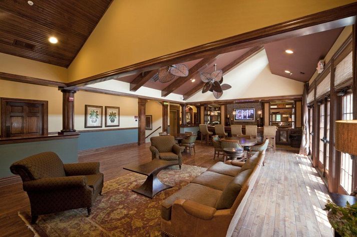 Common area with plenty of seating and over-sized windows providing a lot of natural light