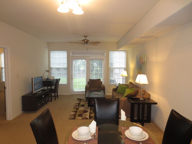 Spacious living room with dining ara, entertainment center and convenient work desk