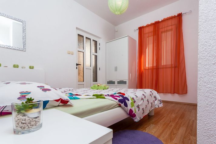 White bedroom with a terrace and access to swimming pool