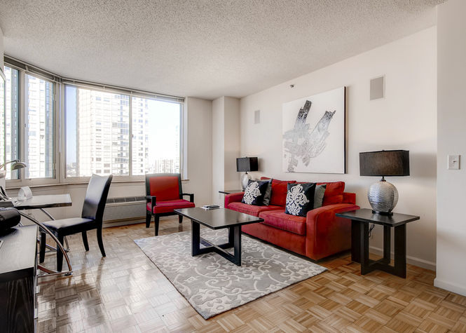 Comfortable living room with pullout sofa bed and club chair