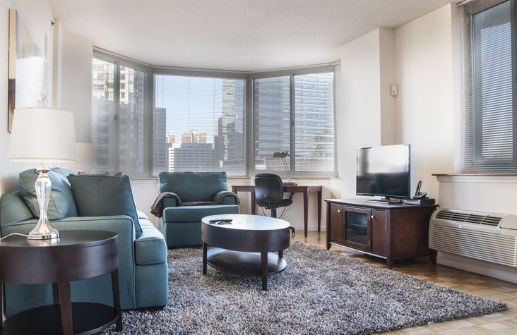 Living room with entertainment center including flat panel LCD TV, DVD/VCR player and CD stereo system