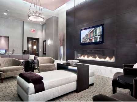 Community room with lots of seating, flat screen TV and fireplace