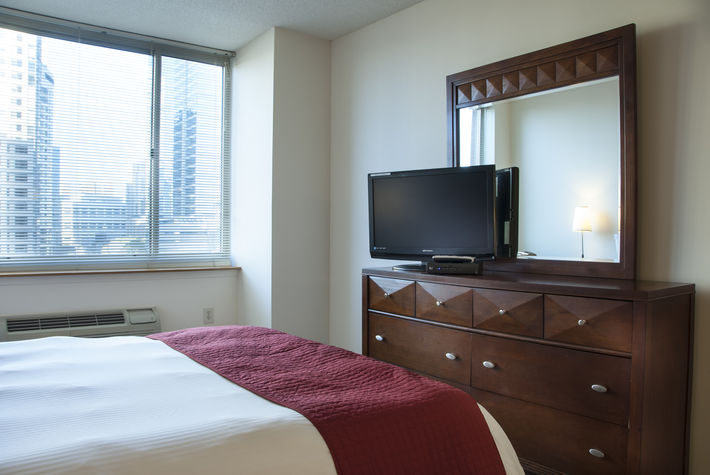 Master bedroom with dresser and flat screen TV