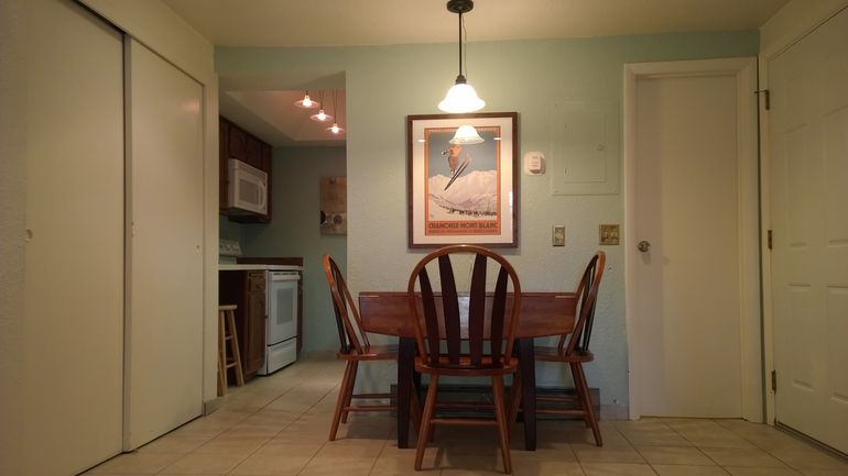 Dining area with expandable wooden table for additional seating.